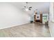 Spacious living room with wood-look tile flooring, a brick fireplace and an open floor plan at 4107 E Fairview Cir, Mesa, AZ 85206