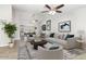 Open-concept living room with neutral decor, ceiling fans, and views into dining and kitchen areas at 4107 E Fairview Cir, Mesa, AZ 85206