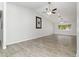 Generous living space featuring wood-look tile, recessed lighting, and a vaulted ceiling with fan at 4107 E Fairview Cir, Mesa, AZ 85206