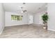 Bright living room with wood-look tile flooring, a large window, and a view of the covered patio at 4107 E Fairview Cir, Mesa, AZ 85206