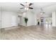 Open-concept living area featuring wood-look tile, neutral paint, and seamless flow to the kitchen at 4107 E Fairview Cir, Mesa, AZ 85206
