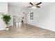Spacious living room boasts wood-look tile, neutral paint, multiple ceiling fans, and open floor plan at 4107 E Fairview Cir, Mesa, AZ 85206