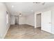 Open-concept living room with neutral paint, recessed lighting, and wood-look tile flooring at 4107 E Fairview Cir, Mesa, AZ 85206