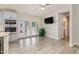 Open living space adjacent to kitchen, bright with natural light through French doors to the backyard at 4107 E Fairview Cir, Mesa, AZ 85206