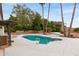 Backyard pool with surrounding concrete pool deck and shade trees at 4107 E Fairview Cir, Mesa, AZ 85206