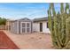View of a small, grey shed with white trim, providing ample storage, next to the cactus at 4107 E Fairview Cir, Mesa, AZ 85206