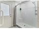 Walk in shower with neutral tile, custom fixtures, and stylish glass shelving at 4107 E Fairview Cir, Mesa, AZ 85206