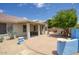Covered back patio with a seating area, desert landscaping, a grill, and a beautiful blue sky at 4141 W Potter Dr, Glendale, AZ 85308