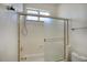 Clean bathroom showcasing a tub with sliding glass doors at 4141 W Potter Dr, Glendale, AZ 85308