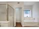 Bathroom featuring a glass shower, garden tub, and adjacent water closet at 4141 W Potter Dr, Glendale, AZ 85308