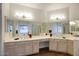 Bathroom with a double sink vanity featuring bright lighting, hardwood floors and large mirrors at 4141 W Potter Dr, Glendale, AZ 85308