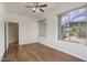 This bedroom has three windows, wood-look floors, and neutral paint, and ceiling fan at 4141 W Potter Dr, Glendale, AZ 85308