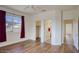 Bedroom boasting two entry points, hardwood floors, natural light, and a glimpse into the ensuite and walk-in closet at 4141 W Potter Dr, Glendale, AZ 85308