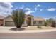 Tan home featuring low maintenance desert landscaping, an arched entryway, and a two-car garage at 4141 W Potter Dr, Glendale, AZ 85308