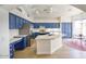 Open kitchen with blue cabinetry, stainless steel appliances, island, and attached breakfast nook at 4141 W Potter Dr, Glendale, AZ 85308