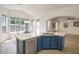 Bright kitchen with blue cabinets, island with a sink, and breakfast nook at 4141 W Potter Dr, Glendale, AZ 85308