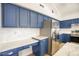 Kitchen featuring blue cabinets, stainless steel appliances, and marble countertops at 4141 W Potter Dr, Glendale, AZ 85308