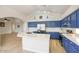 Open kitchen with blue cabinetry, stainless steel appliances, island, and an open layout at 4141 W Potter Dr, Glendale, AZ 85308