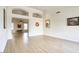 Spacious living room with wood-look floors, high ceilings, and decorative archways at 4141 W Potter Dr, Glendale, AZ 85308