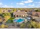 Spacious home with a luxurious backyard, featuring a pool, putting green, and lounge area, set in a vibrant neighborhood at 4448 E Sleepy Ranch Rd, Cave Creek, AZ 85331