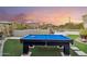 Entertaining backyard featuring a pool table, fireplace, and lounge area, ideal for outdoor gatherings and leisure at 4448 E Sleepy Ranch Rd, Cave Creek, AZ 85331
