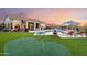 Expansive backyard with a pool, putting green, and lounge area, ideal for recreation and gatherings at 4448 E Sleepy Ranch Rd, Cave Creek, AZ 85331