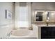 Bright bathroom featuring a soaking tub, natural light, and dual mirrors at 4448 E Sleepy Ranch Rd, Cave Creek, AZ 85331