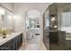 Bathroom featuring dual sinks, a stand alone shower, and bedroom entrance at 4448 E Sleepy Ranch Rd, Cave Creek, AZ 85331
