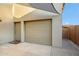 Neutral garage door with entry door situated underneath a shade structure at 4448 E Sleepy Ranch Rd, Cave Creek, AZ 85331