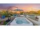 Relaxing hot tub and pool area, complete with an umbrella, lounge seating, and desert landscape at 4448 E Sleepy Ranch Rd, Cave Creek, AZ 85331