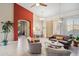 Open living room with neutral tones, tile floors, and an arched entryway with a red accent wall at 4448 E Sleepy Ranch Rd, Cave Creek, AZ 85331