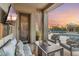 Inviting covered patio with plush seating, a fire table, and a TV overlooking the pool area at 4448 E Sleepy Ranch Rd, Cave Creek, AZ 85331