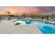 Luxurious pool area with a seating area, fireplace, and beautiful sunset at 4448 E Sleepy Ranch Rd, Cave Creek, AZ 85331