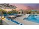 Outdoor pool area with a fireplace, lounge seating, and desert landscaping at 4448 E Sleepy Ranch Rd, Cave Creek, AZ 85331