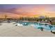 Resort-style pool area with a tanning ledge, outdoor seating, and a beautiful sunset view at 4448 E Sleepy Ranch Rd, Cave Creek, AZ 85331