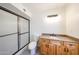 Updated bathroom featuring a shower and granite countertops and wood cabinetry at 4528 W Butler Dr, Glendale, AZ 85302