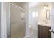 Bathroom features a glass enclosed shower and modern vanity with sink and fixture at 4528 W Butler Dr, Glendale, AZ 85302