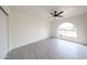 Bright bedroom with gray tiled flooring, a ceiling fan, and a window letting in ample light at 4528 W Butler Dr, Glendale, AZ 85302