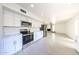 Bright and modern kitchen featuring stainless steel appliances, sleek white cabinetry, and tile floors at 4528 W Butler Dr, Glendale, AZ 85302