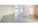 Open living room with light tile floors, great natural light, brick column, and wood doors at 4528 W Butler Dr, Glendale, AZ 85302