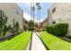 Exterior view of the building showcasing a well-maintained lawn and desert landscaping at 4630 N 68Th St # 221, Scottsdale, AZ 85251
