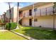 Apartment building exterior with green lawn, walkways, and stairs to upper level units at 4630 N 68Th St # 221, Scottsdale, AZ 85251