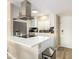 Bright kitchen with stainless steel appliances, white cabinets, tile backsplash, and modern fixtures at 4630 N 68Th St # 221, Scottsdale, AZ 85251