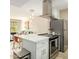 Bright kitchen features stainless steel appliances, white cabinets, and an island overlooking the living area at 4630 N 68Th St # 221, Scottsdale, AZ 85251