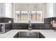 Close-up of kitchen sink with stainless steel faucet and tile backsplash overlooking outdoor view at 4630 N 68Th St # 221, Scottsdale, AZ 85251