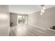 Spacious living room featuring wood floors, sliding glass doors, and modern lighting fixtures at 4630 N 68Th St # 221, Scottsdale, AZ 85251