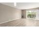 Bright living room featuring wood floors, sliding glass doors, and modern lighting fixtures at 4630 N 68Th St # 221, Scottsdale, AZ 85251