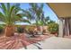 Relaxing backyard patio with comfortable seating, lush plants, and a vibrant desert landscape at 5502 N Ormondo Way, Litchfield Park, AZ 85340