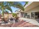 A comfortable backyard patio with chairs, table and grill is ready for entertaining at 5502 N Ormondo Way, Litchfield Park, AZ 85340