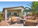 Comfortable backyard space is ready to enjoy with a seating area, grill and landscaping at 5502 N Ormondo Way, Litchfield Park, AZ 85340